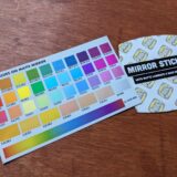 The color card and back of the matte mirror-printed stickers. The back of the sticker has a repeating motif that says Back Printing, and a label identifying the print stock.