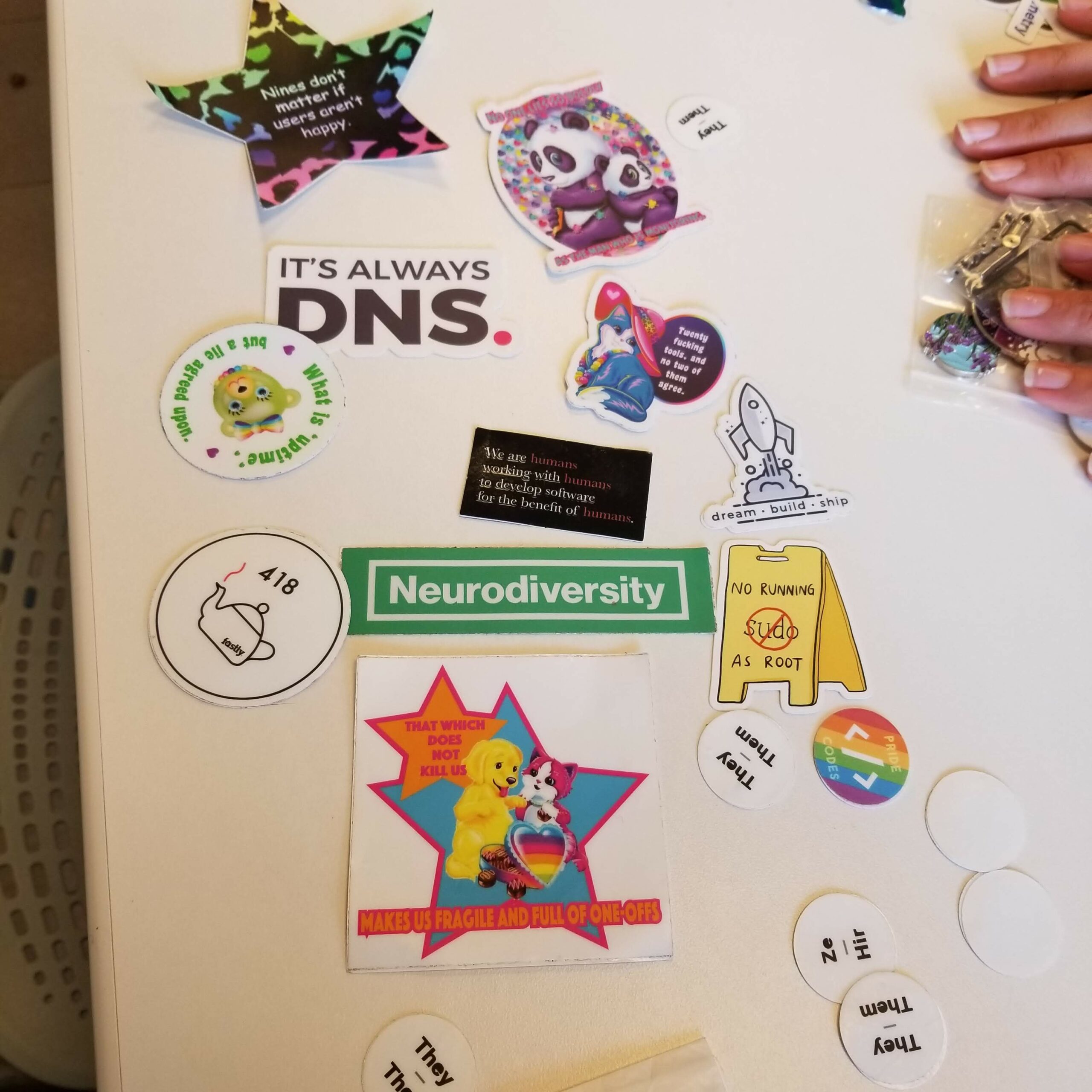 A set of stickers that I think are cool. One says "It's always DNS." Another says "Neurodiversity".