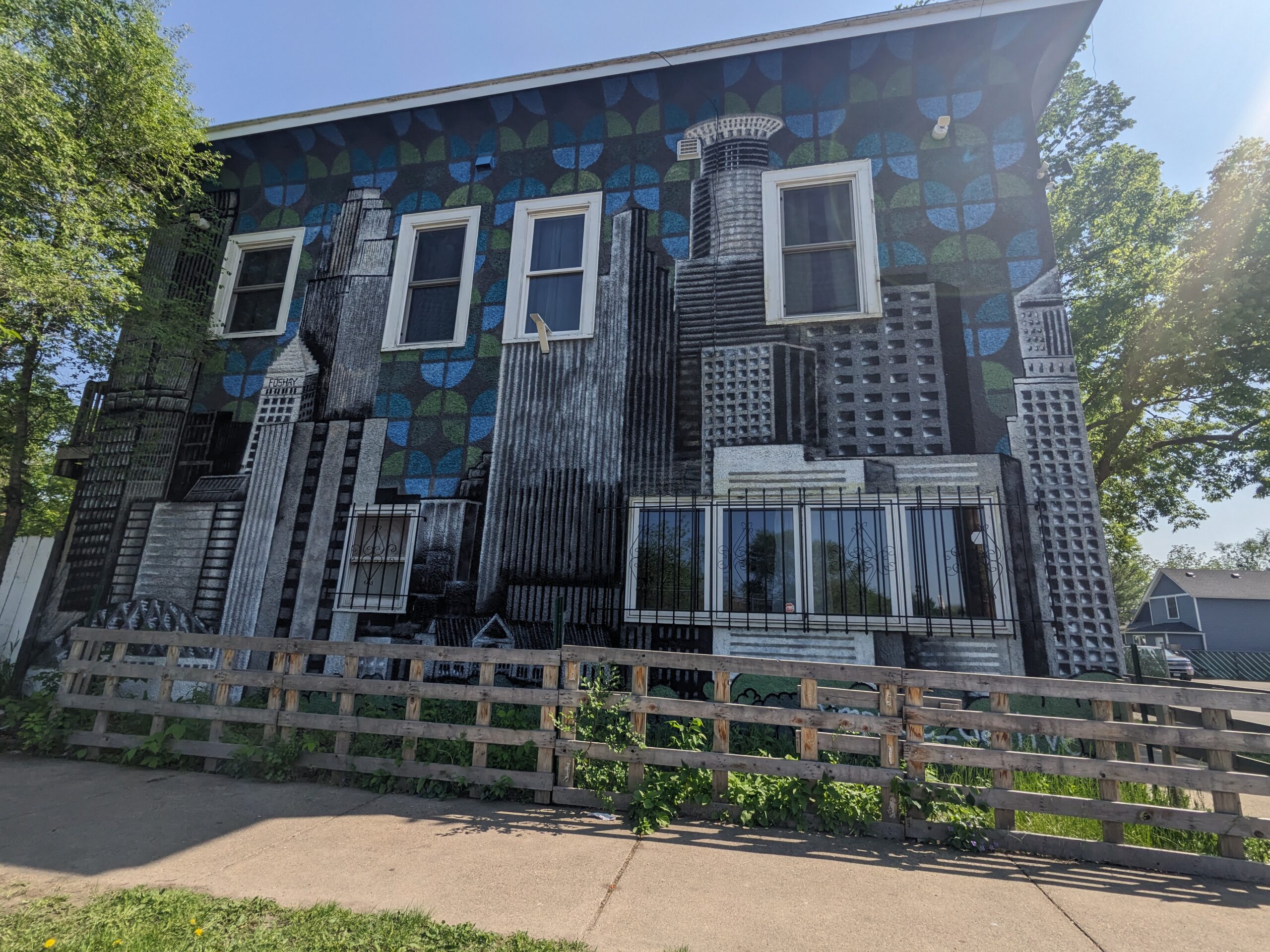 A mural of the Minneapolis skyline painted on the side of a residential building in the Phillips neighborhood